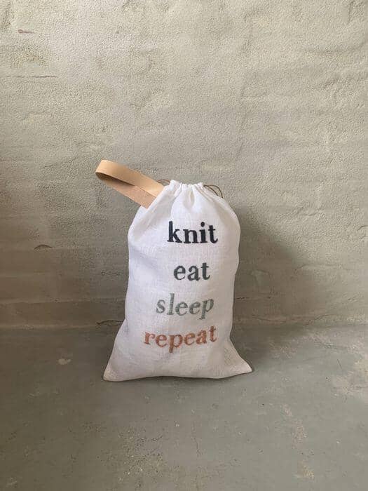 Project bag with embroidered text knit, eat, sleep, repeat, standing