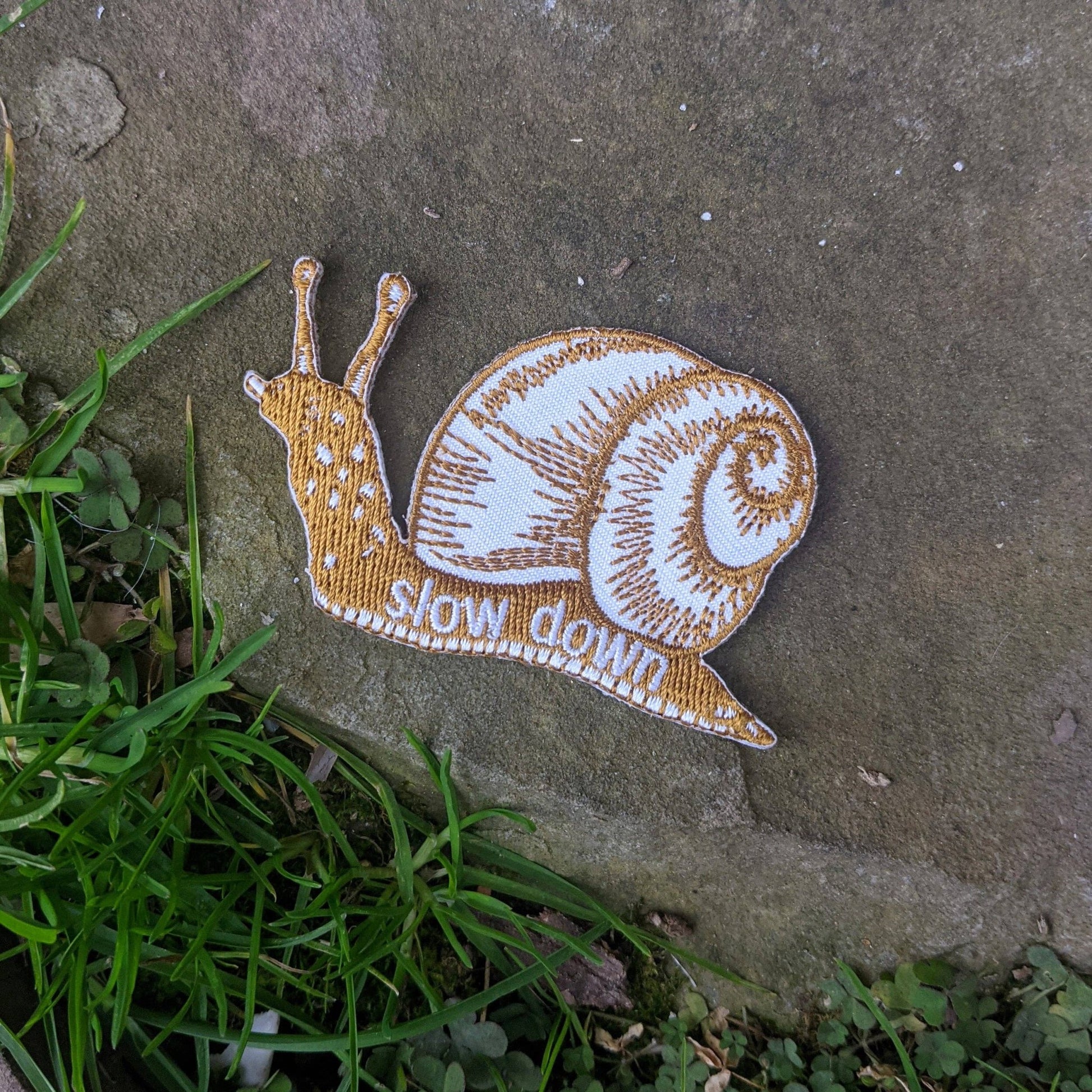 Iron - on patch | slow down snail - brown 1.6" x 2.6" - homesewn