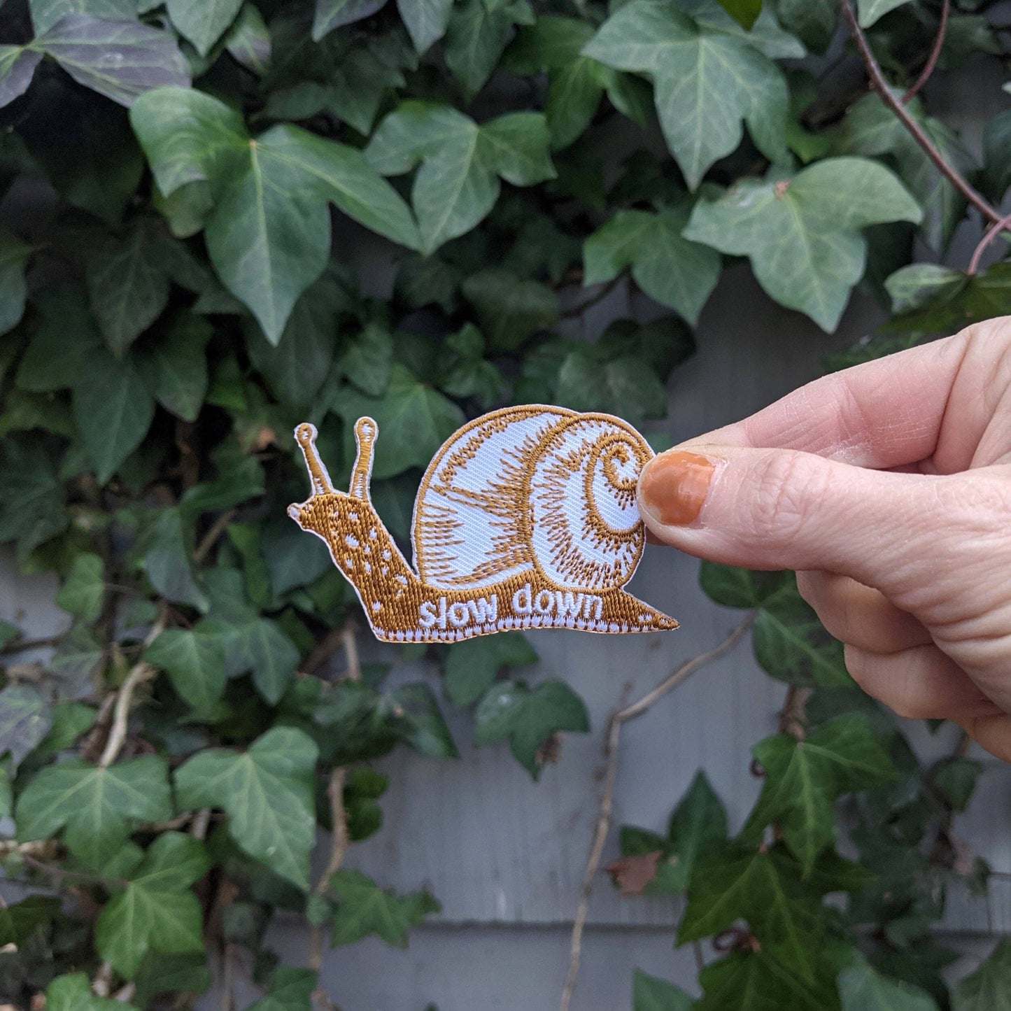 Iron - on patch | slow down snail - brown 1.6" x 2.6" - homesewn